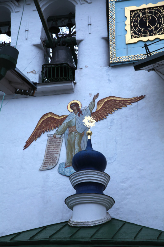 angel bearing text and bells and clock from Pskov Monastery of the Caves